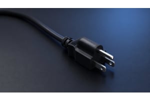 NEMA 5-15P three-prong power plug with narrow hot blade, wide neutral blade, and U-shaped ground pin on a clean studio background